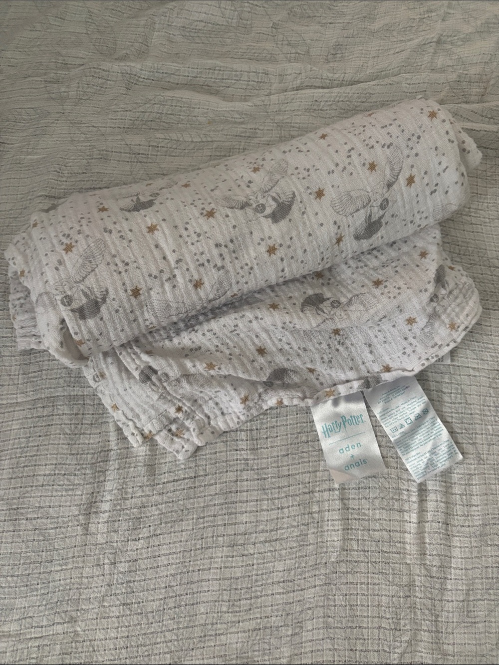 aden + anais White Muslin Swaddle with Gold and Gray Snitch Print